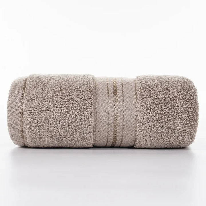 Khaki beige face towel roll with stitched stripe bands and plush looped texture