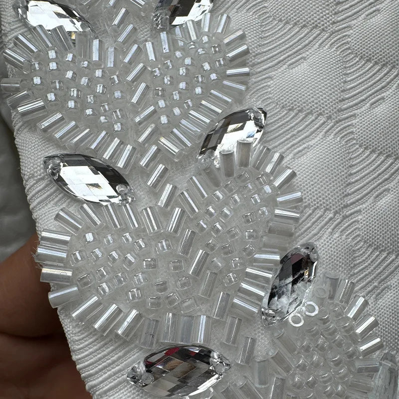 Close-up of a decorative silver mask with crystal-like embellishments.