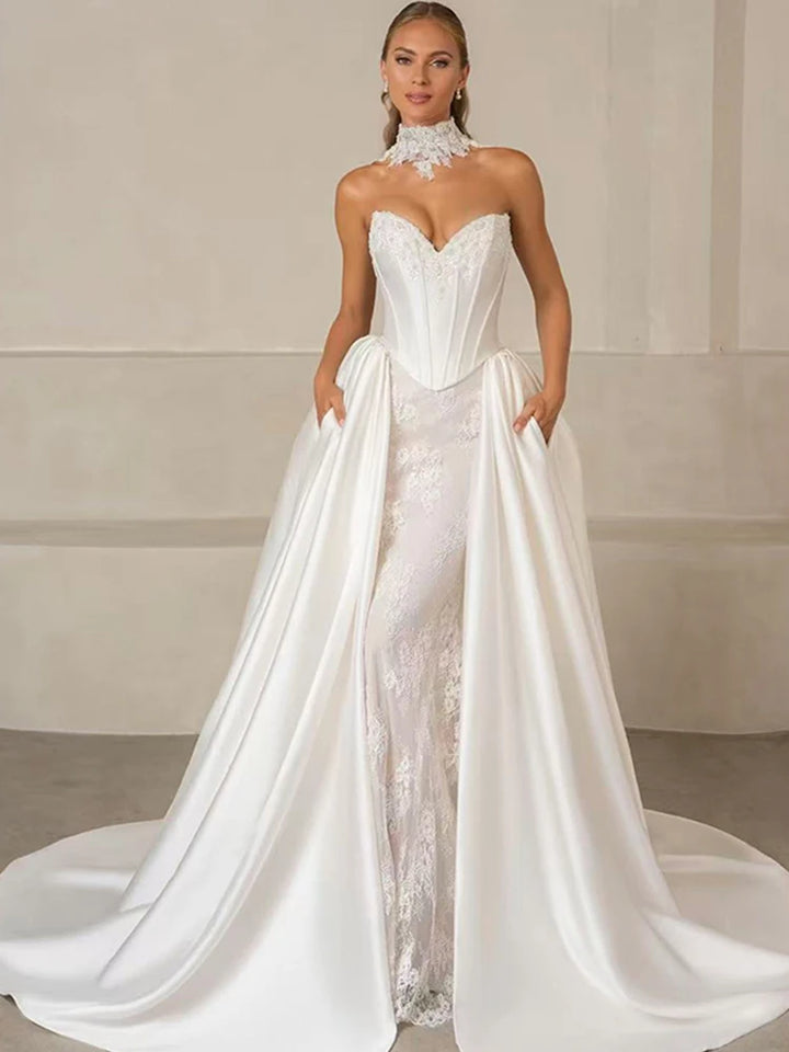 White strapless bridal gown with lace bodice, sweetheart neckline, and satin skirt train.