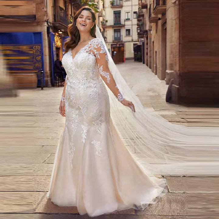 Applique bridal ball gown with long sleeves, V-neck, lace bodice, and flowing train