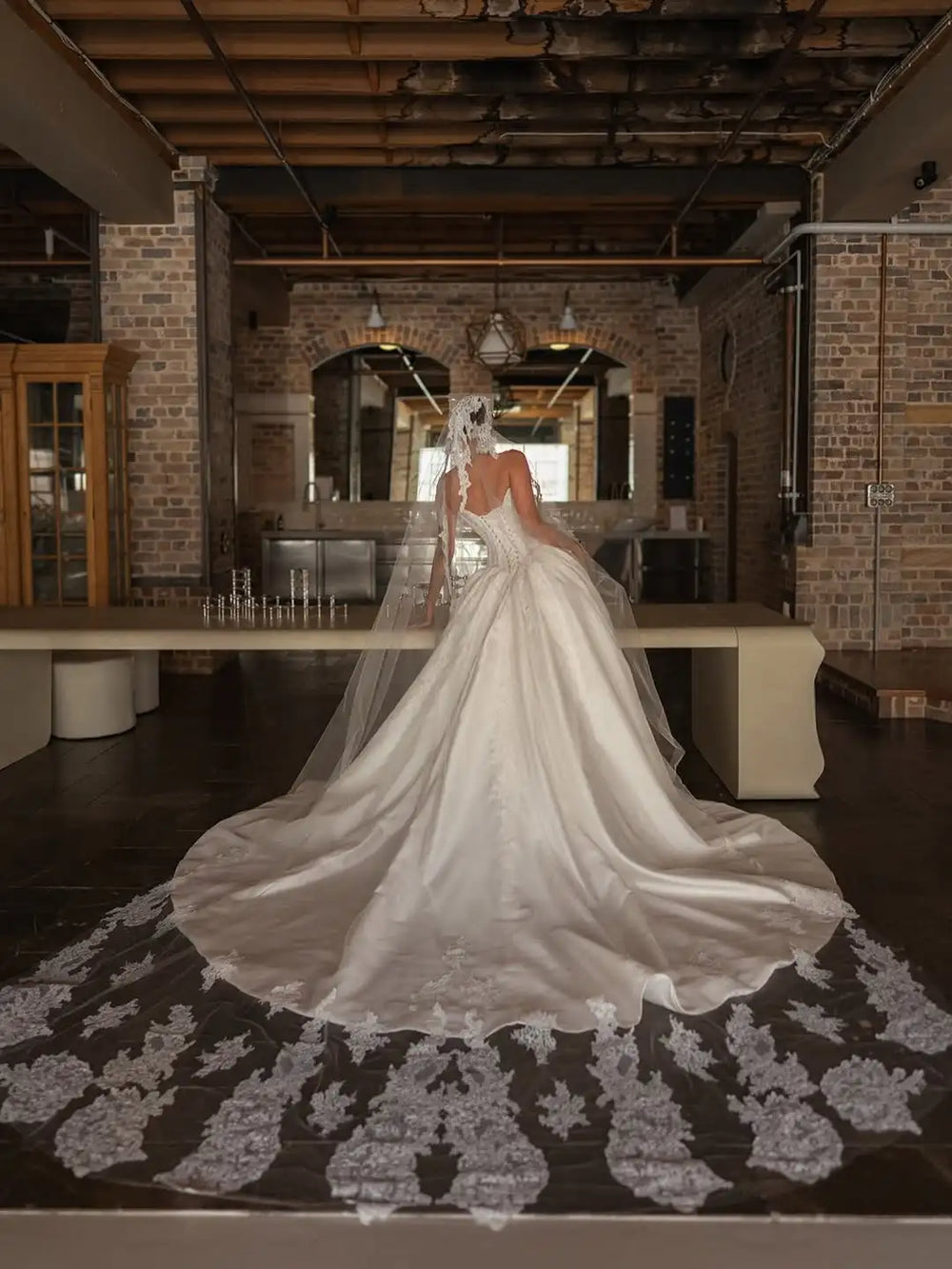 Ivory satin bridal ballgown with high slit, lace corset bodice, and full skirt