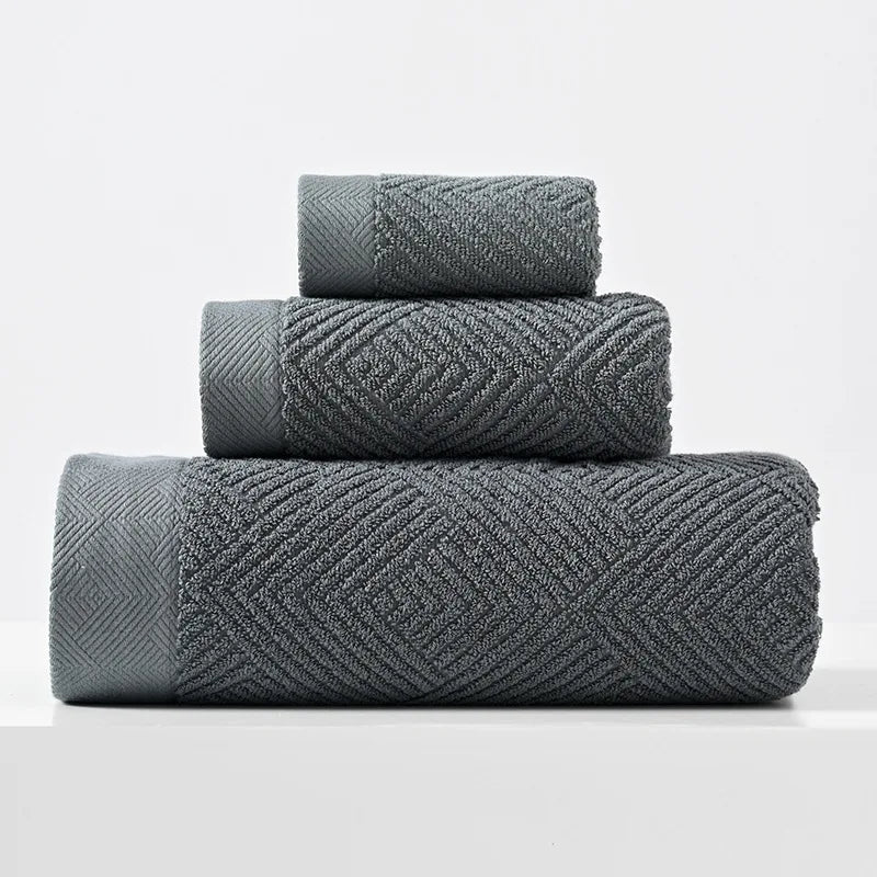 Dark gray cotton towel set with thick chevron weave, stacked folded towels