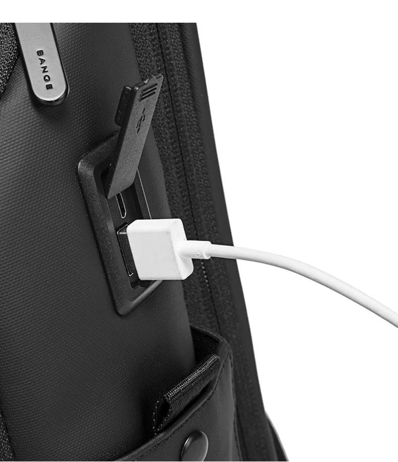 Black backpack with USB charging port and attached cable near side zipper