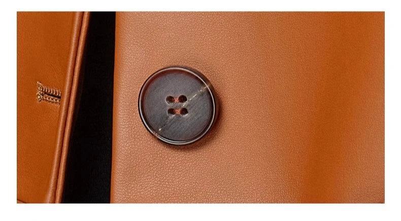 Women’s sheepskin woven coat close-up of round dark button on orange leather