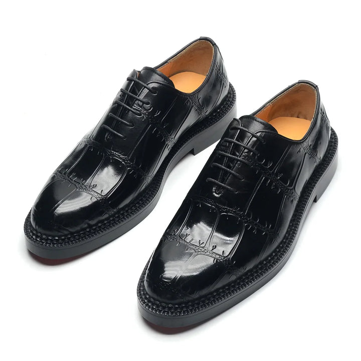 Pair of black dress shoes on a white background