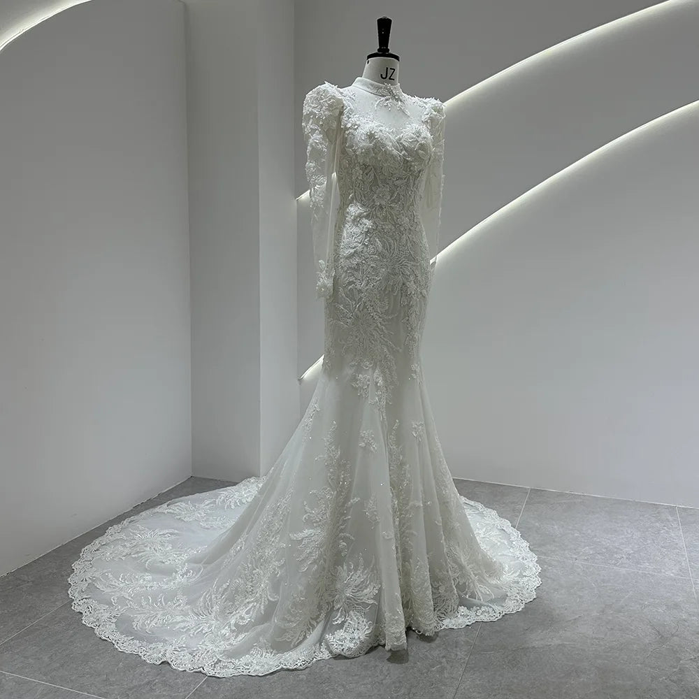 Ivory lace bridal gown with puff shoulders, fitted bodice, and cascading lace train