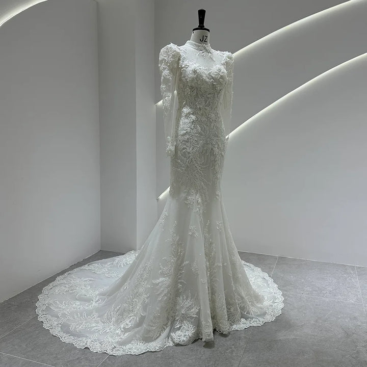 Ivory lace bridal gown with puff shoulders, fitted bodice, and cascading lace train