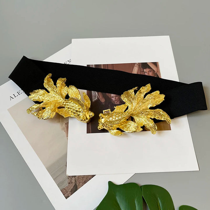 Women’s gold fish buckle waist belt on black strap, accessory styling