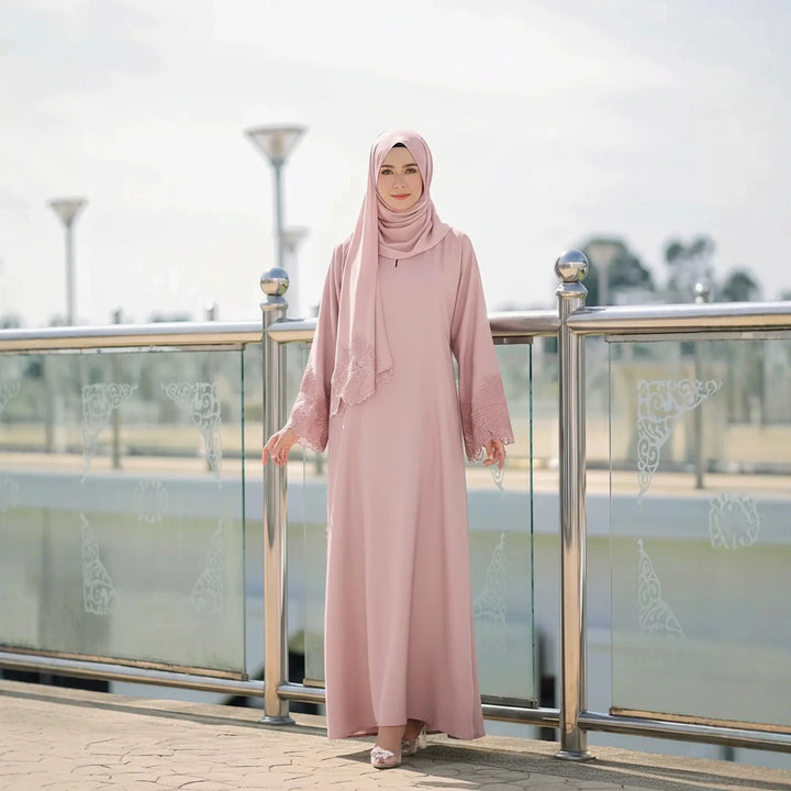 Blush pink modest abaya dress with matching headscarf, lace accents on sleeves