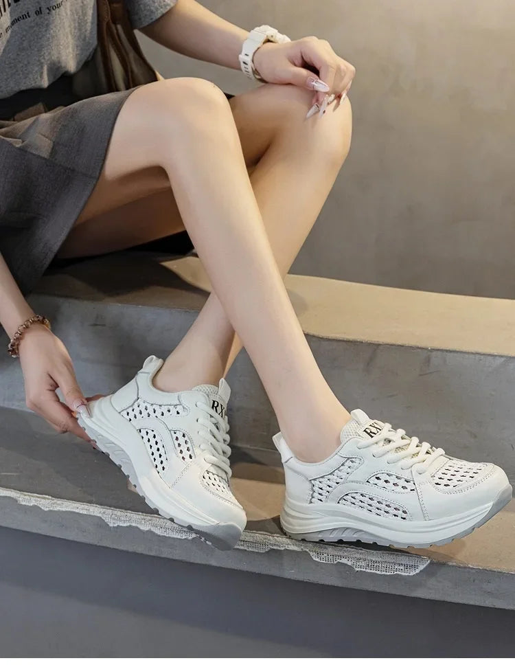 White woven mesh lace-up sneakers with perforated sides and thick rubber sole.