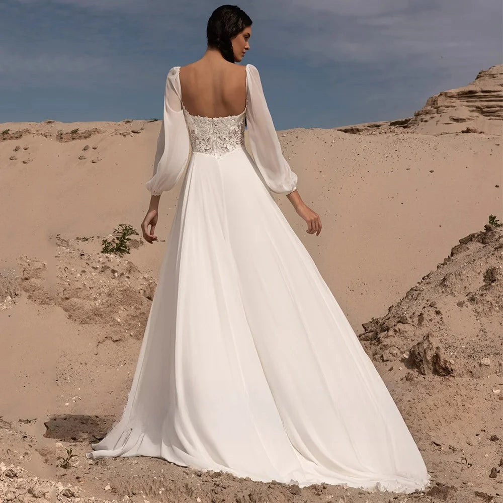 Chiffon bridal gown back view with lace bodice, long puff sleeves, flowing skirt