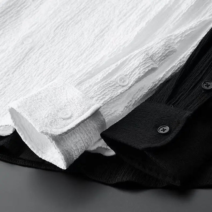 Close-up of white and black shirt collars and buttons