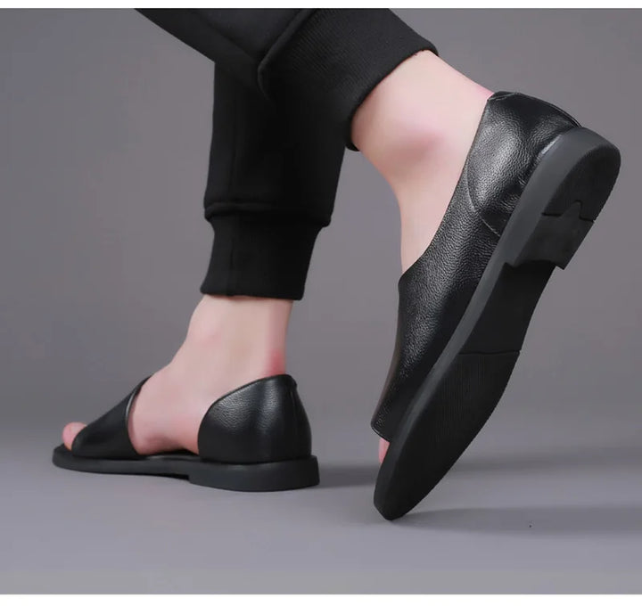 Black leather slip-on sandals on foot with backless open design and sole