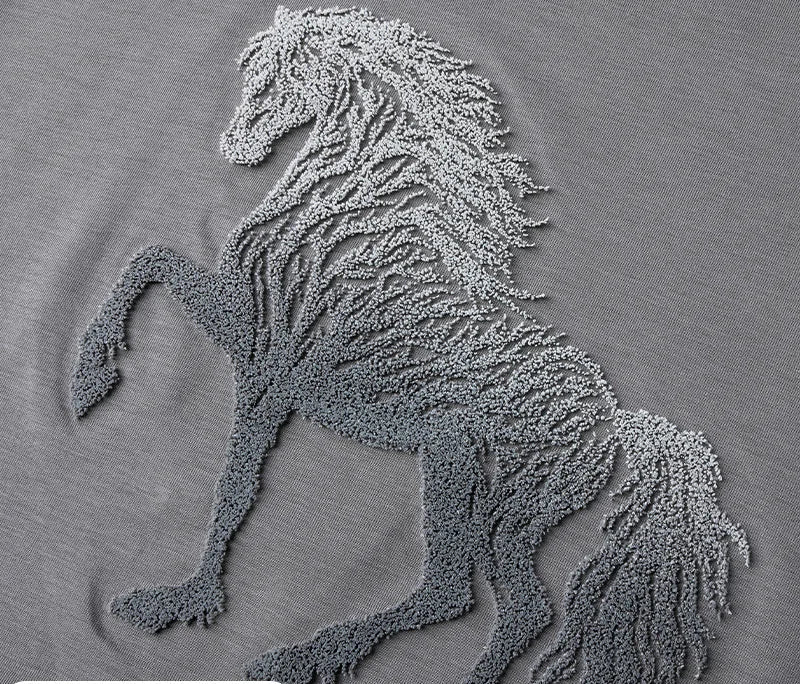 Grey crew-neck T-shirt with detailed horse embroidery close-up.