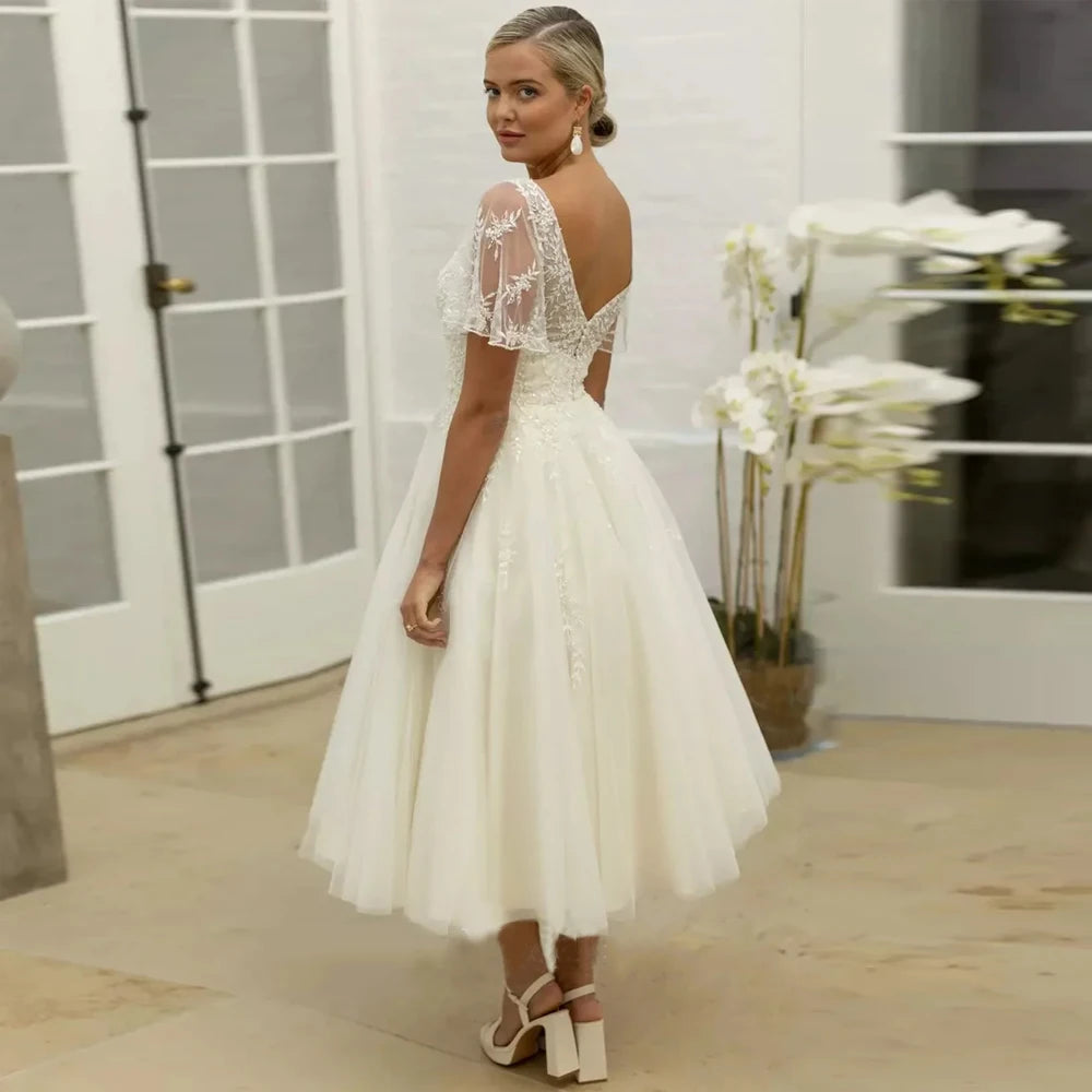 Ivory A-line bridal dress with lace illusion sleeves and open back