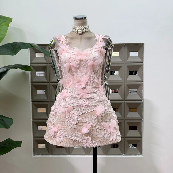 Pink lace corset mini dress with 3D floral ruffles and pearl choker collar