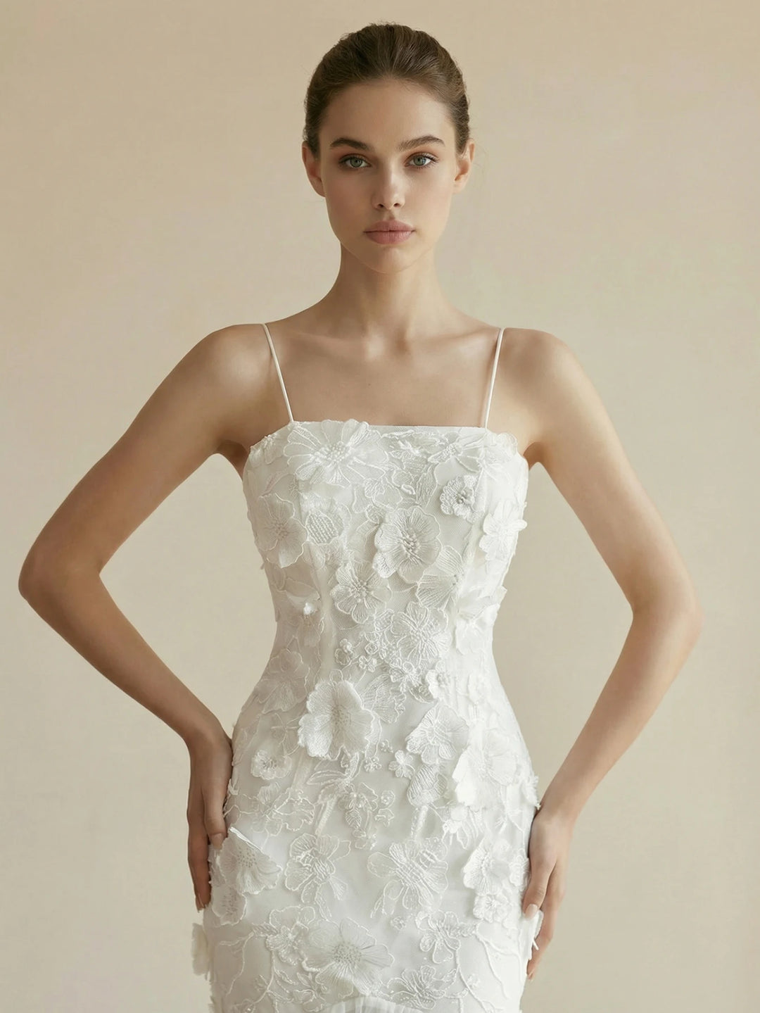 White bodycon bridal gown with spaghetti straps and floral appliqué