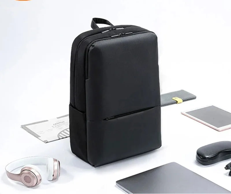 Black travel work backpack with front pocket and top handle