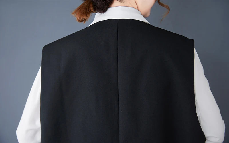 Black sleeveless waistcoat back view with clean center seam