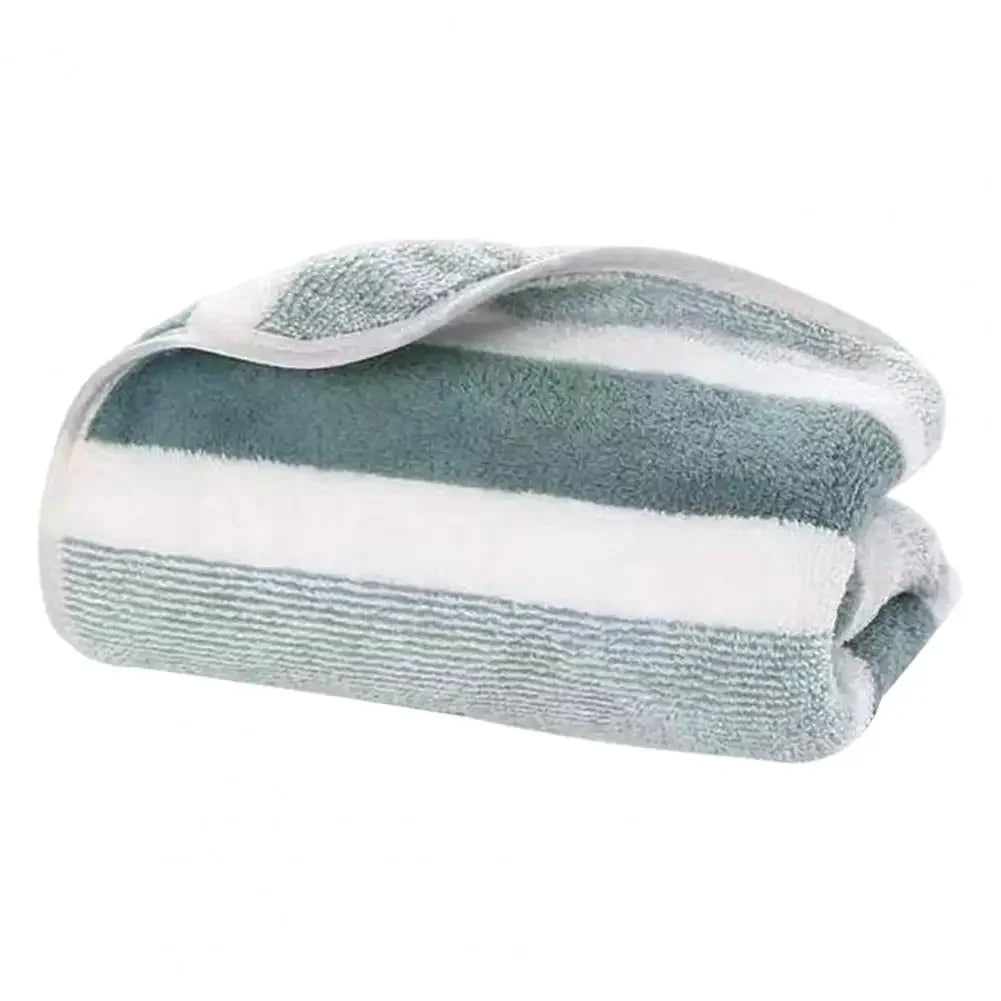 Rolled green-and-white striped terry towel with a folded edge