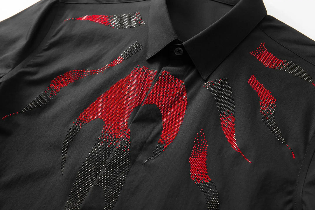 Close-up of black shirt front with red and gray rhinestone drip pattern, button placket