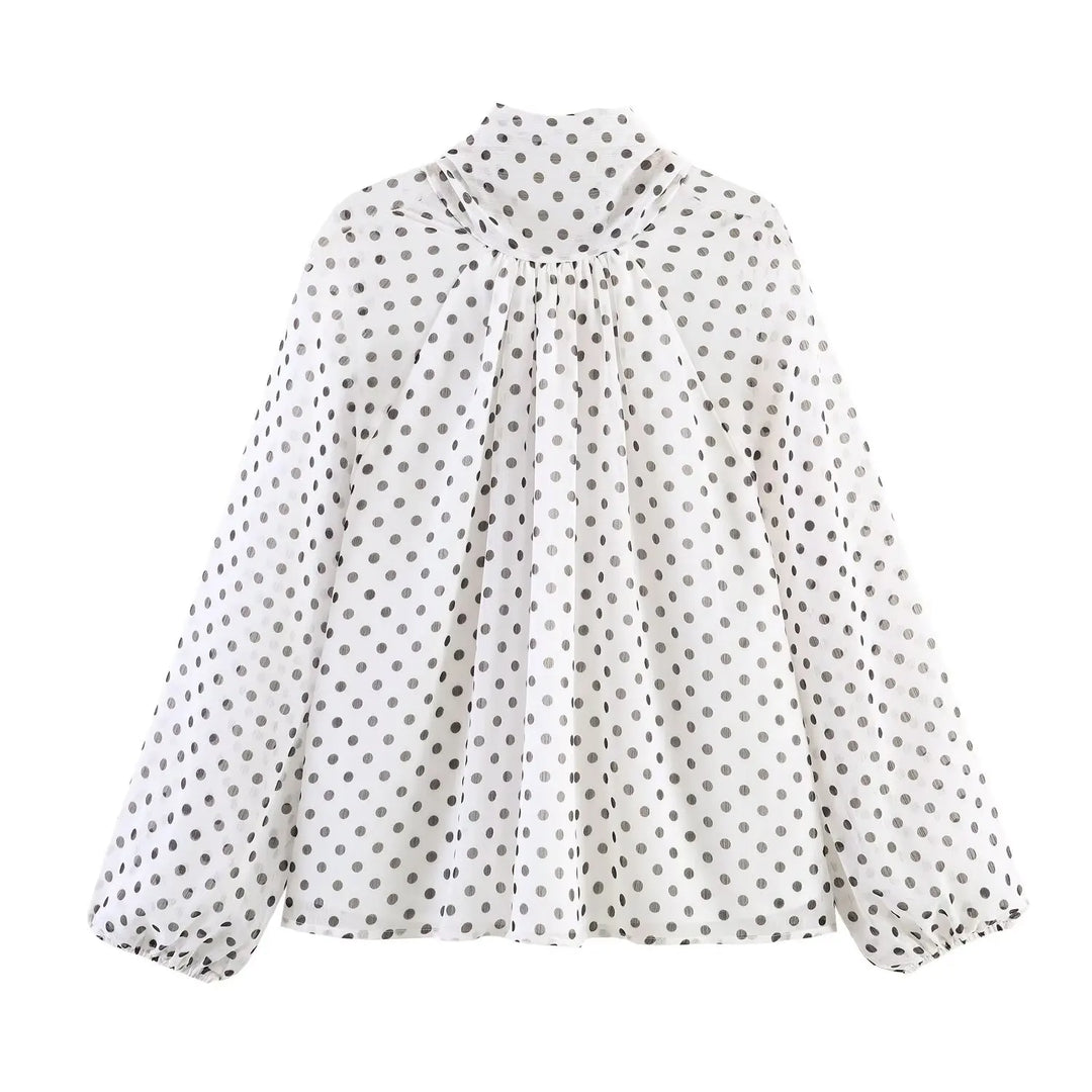 Cream polka-dot high-neck chiffon blouse with gathered front and long puff sleeves, side view