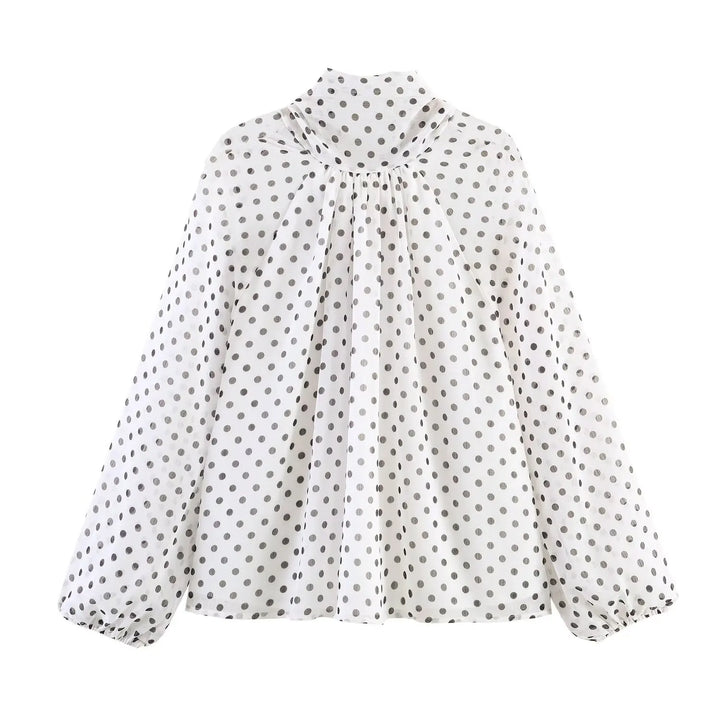 Cream polka-dot high-neck chiffon blouse with gathered front and long puff sleeves, side view
