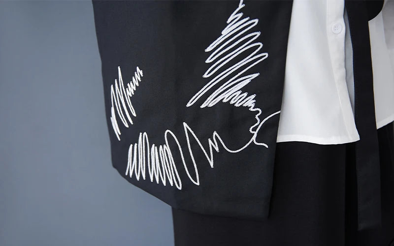 Black waistcoat with white scribble embroidery detail on the front panel