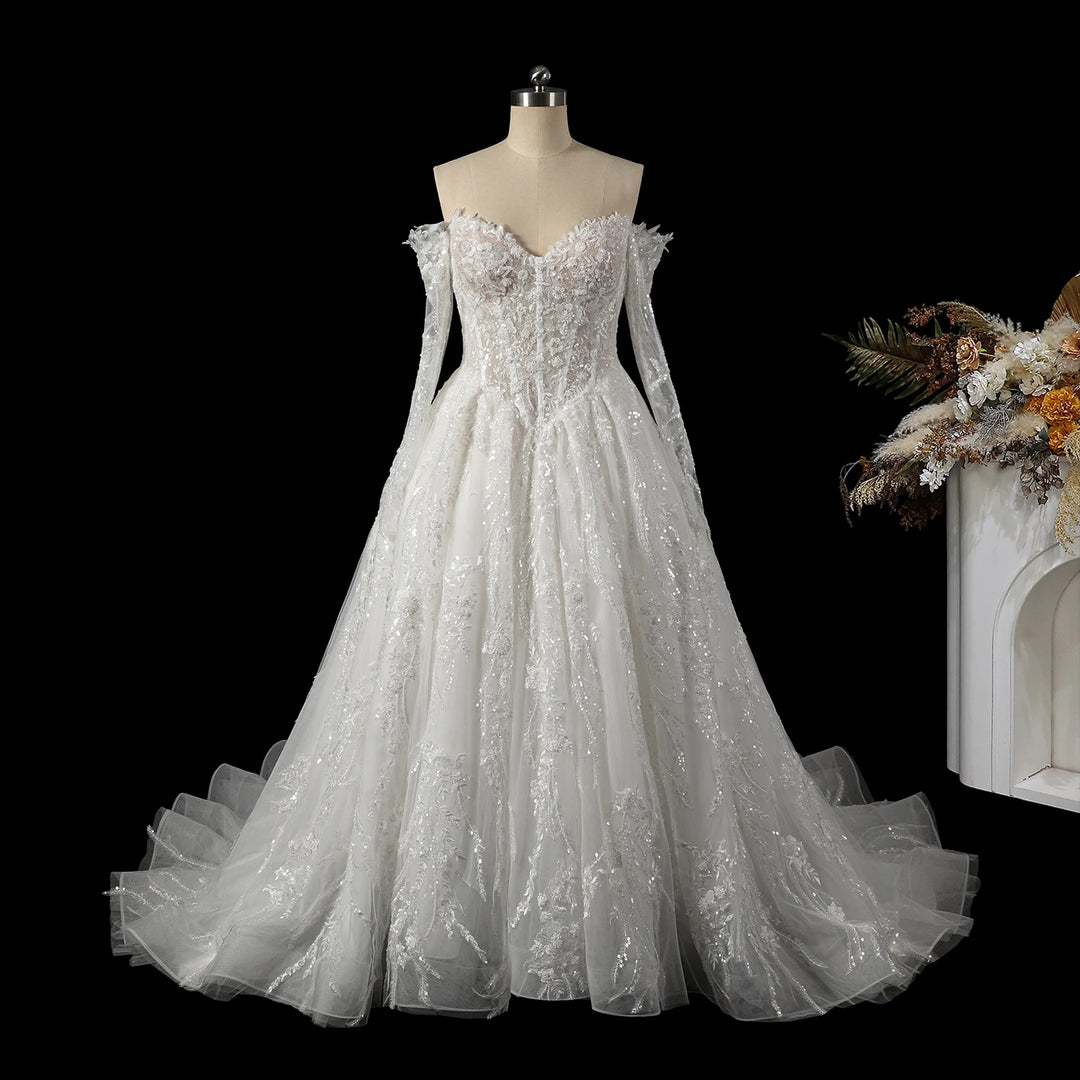 White sequin corset bridal gown on mannequin, off-shoulder lace bodice and full tulle skirt