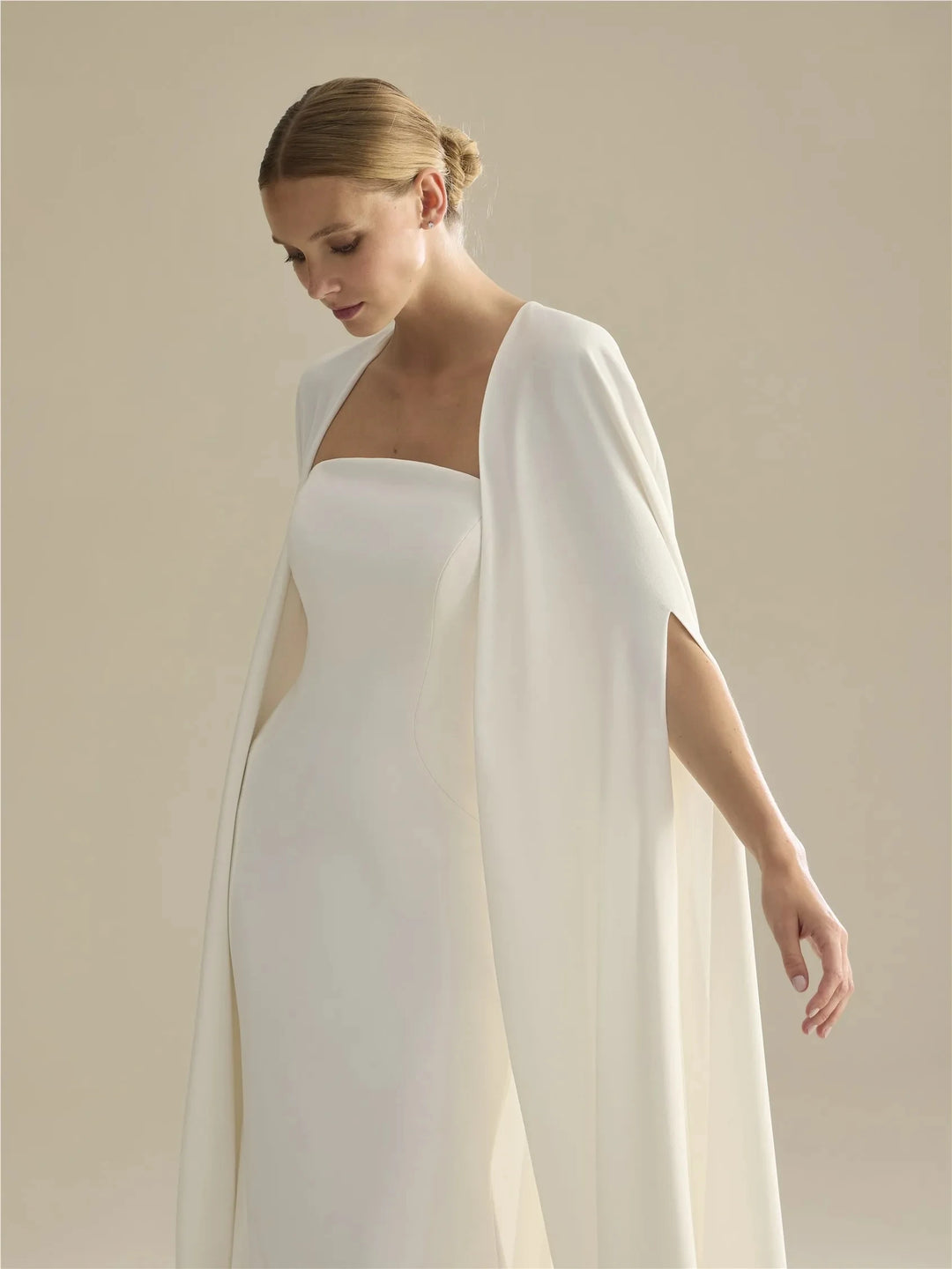 Off-white bridal cape with shoulder drape and sleeveless open front