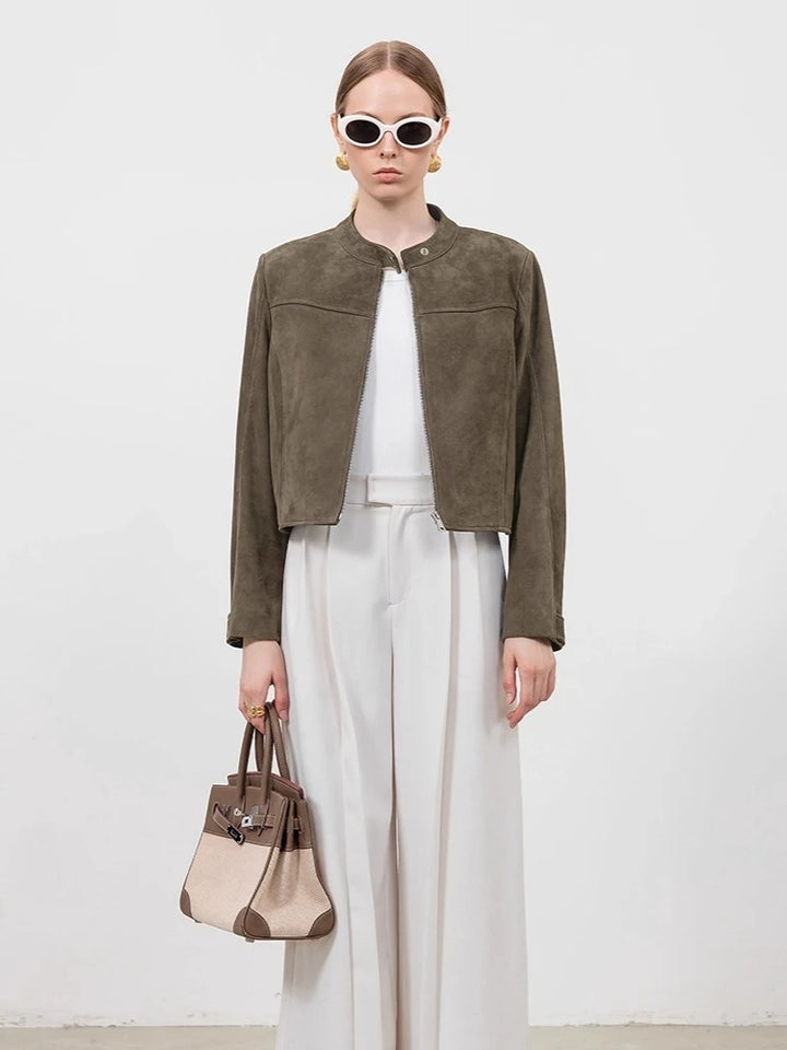 Gray-green suede cropped jacket with snap front, stand collar, worn with white pants
