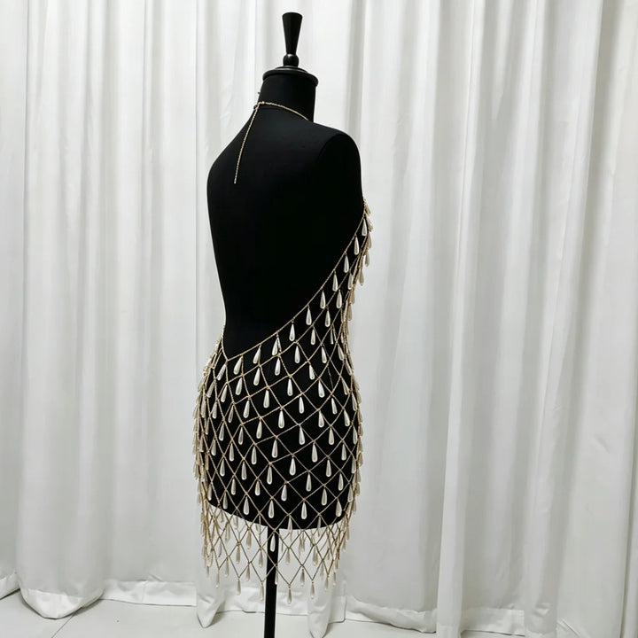 Black sleeveless maternity dress with gold lattice beadwork and long tassel fringe, side