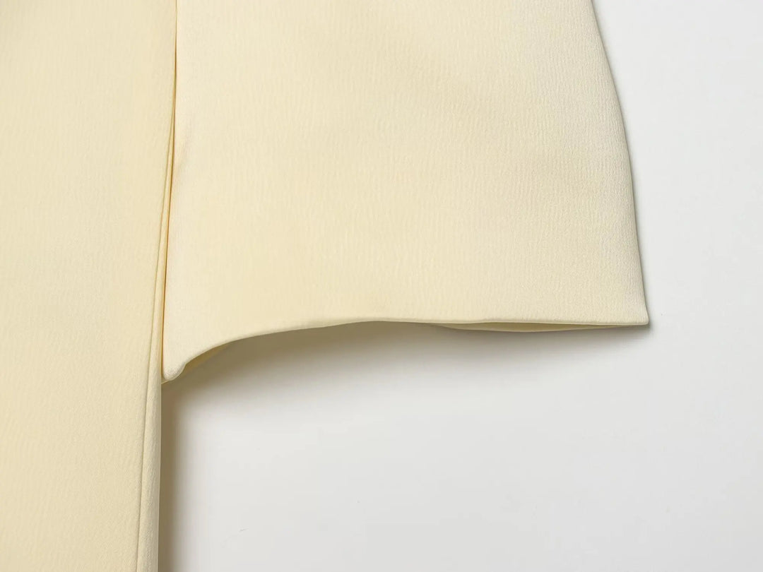 Beige cropped satin blazer sleeve and side seam close-up