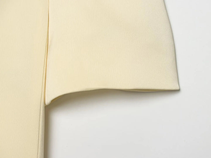 Beige cropped satin blazer sleeve and side seam close-up