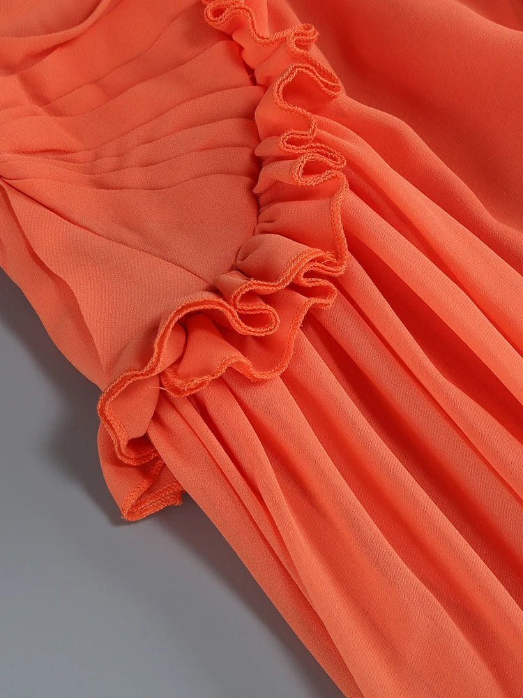 Orange ruffle trim and pleated fabric detail at neckline