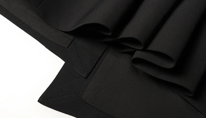 Black midi dress waist detail with structured seams and skirt drape
