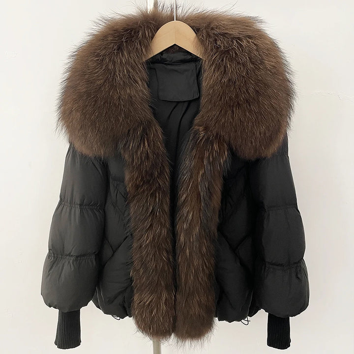 Black puffer coat with oversized dark brown faux-fur collar and front zip, rib-knit cuffs