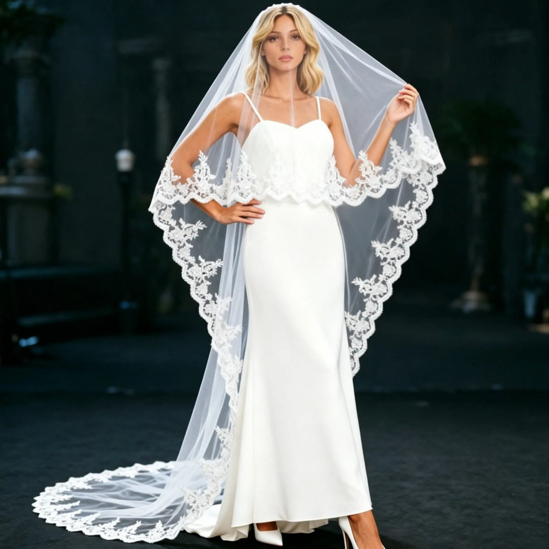 Long white bridal veil with scalloped lace edge draped over shoulders