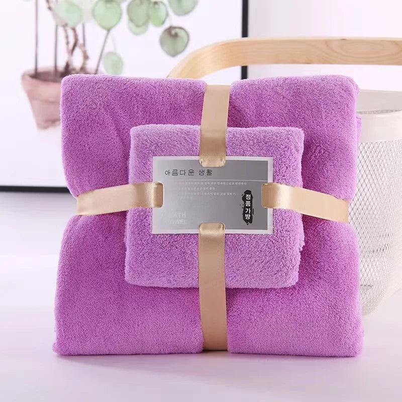 Plush purple 2-piece bath towel set, folded and wrapped with beige ribbon and label