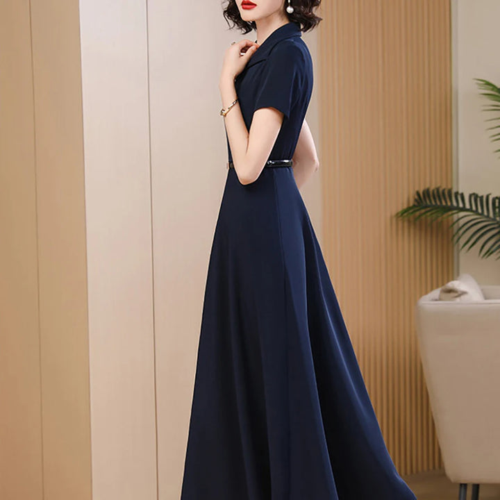 Side view of navy mid-calf A-line dress with V-neck and short sleeves, belted waist