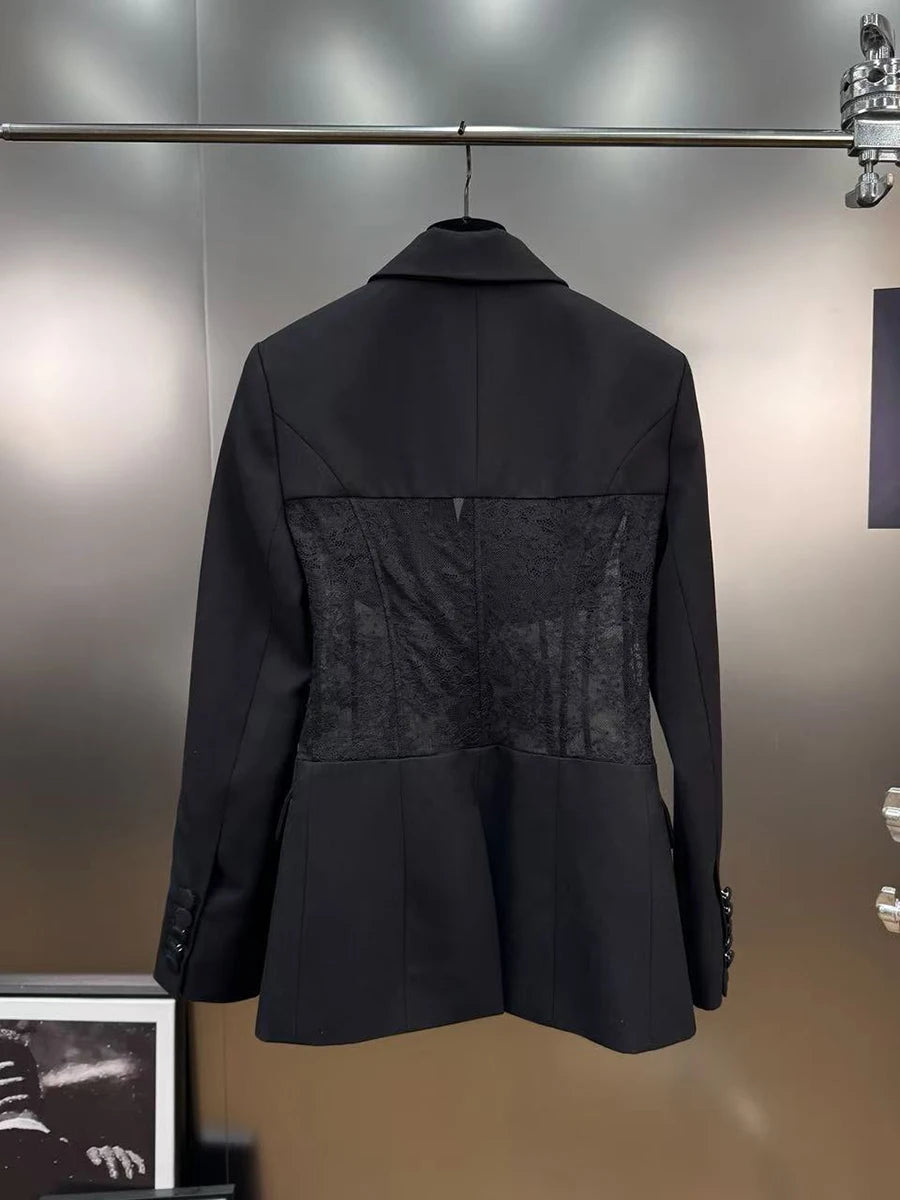 Black blazer with sheer lace back panel, shown hanging on a hanger