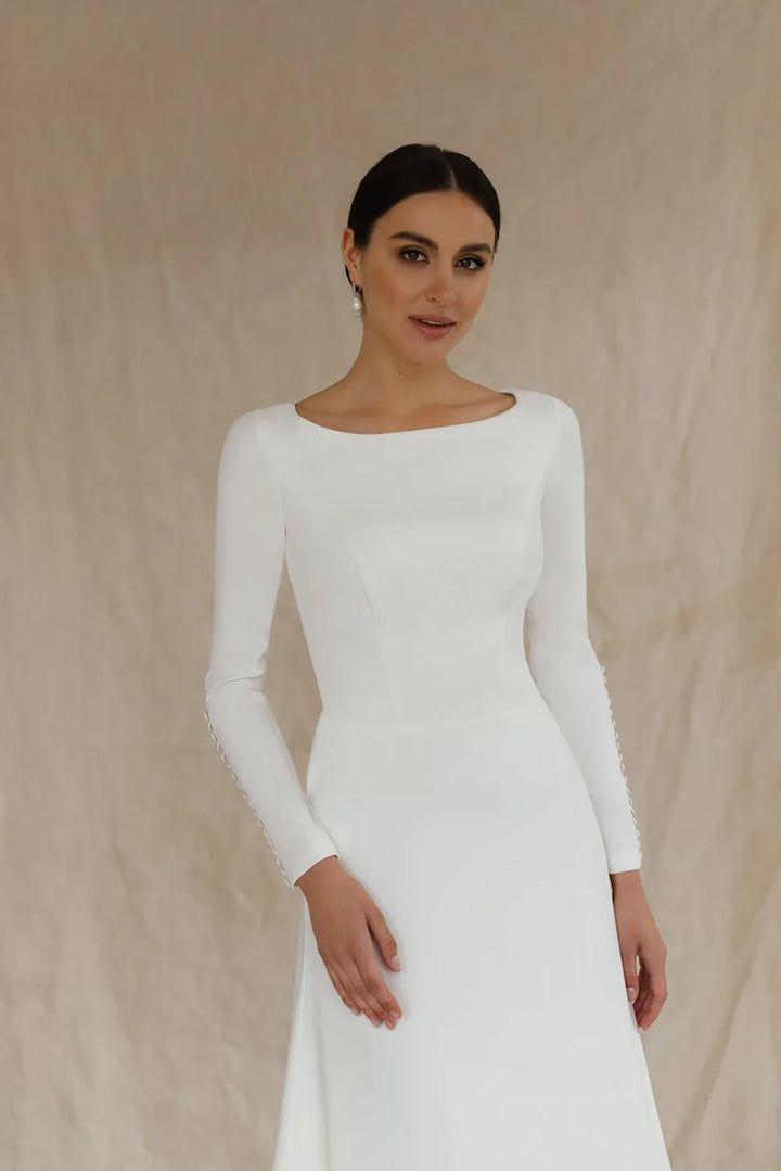 White long-sleeve wedding dress with fitted bodice and A-line skirt