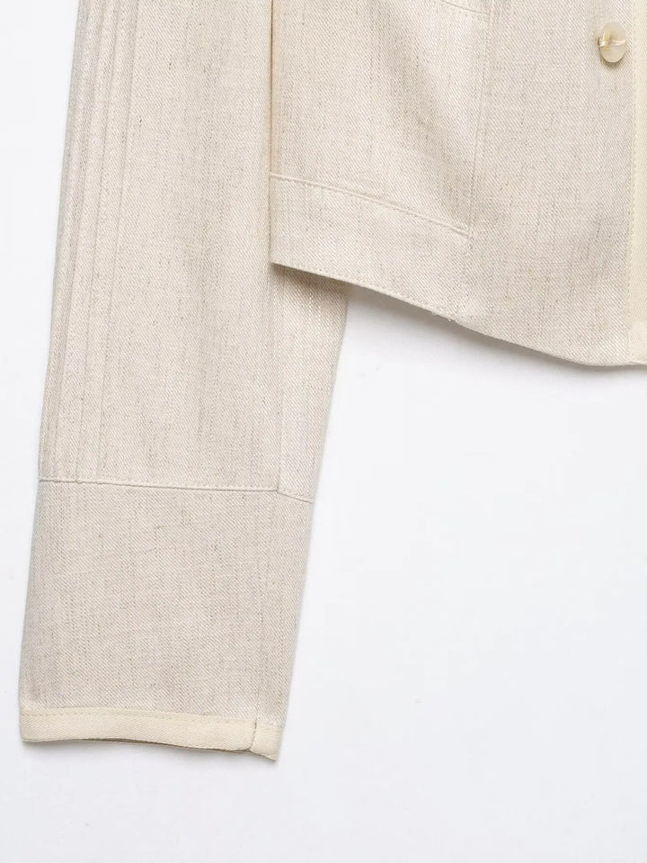 Beige cropped blazer sleeve with stitched cuff and panel seam stitching