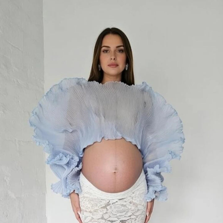 Light blue fluffy crop maternity top with ruffled sleeves and mock neckline