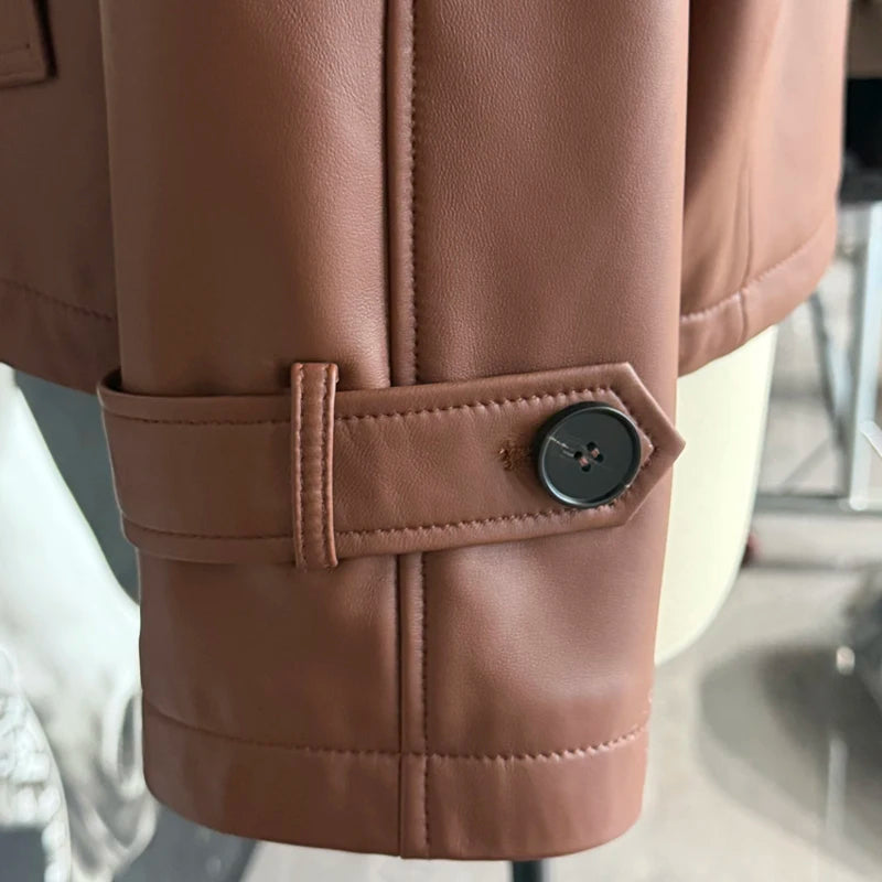 Women’s short leather coat sleeve cuff detail with buttoned strap, caramel-brown