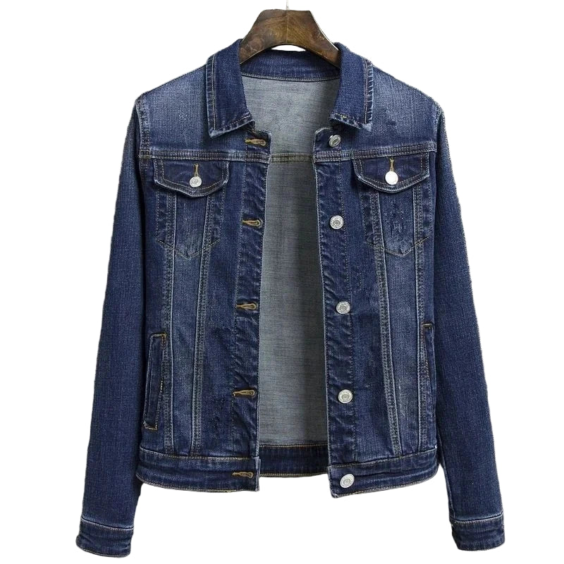 Blue denim jacket on a hanger against a gray textured background