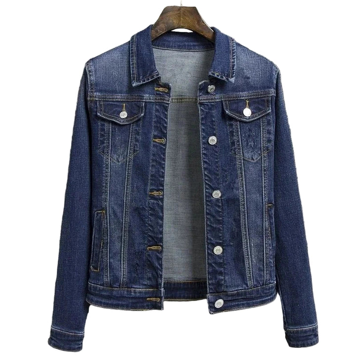 Blue denim jacket on a hanger against a gray textured background