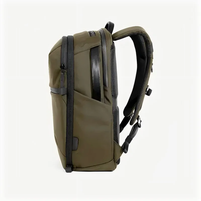 Olive green nylon laptop backpack with front zip pocket, black trim, and padded carry handle