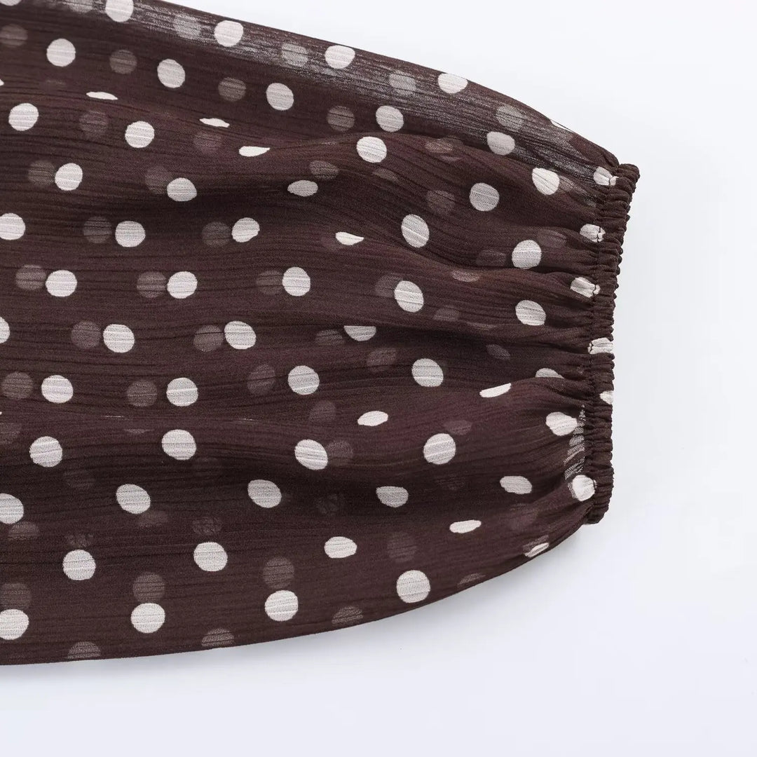 Women’s chiffon high-neck blouse side view, dark brown with white polka dots, ruffled hem