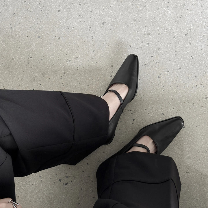Black leather kitten heel pumps with ankle strap and low heel